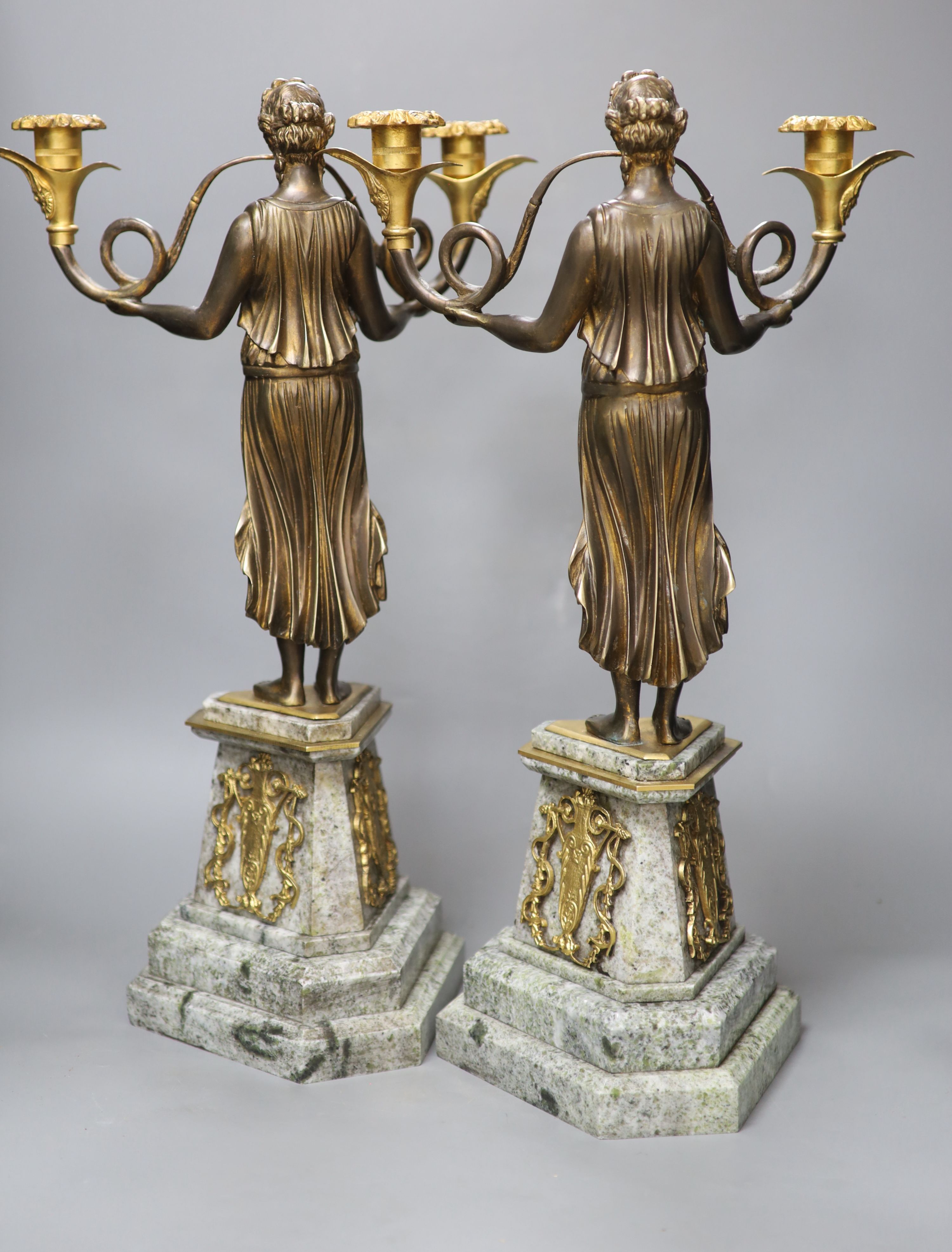 A pair of Louis XVI style gilt metal and marble figural candlesticks, height 52cm